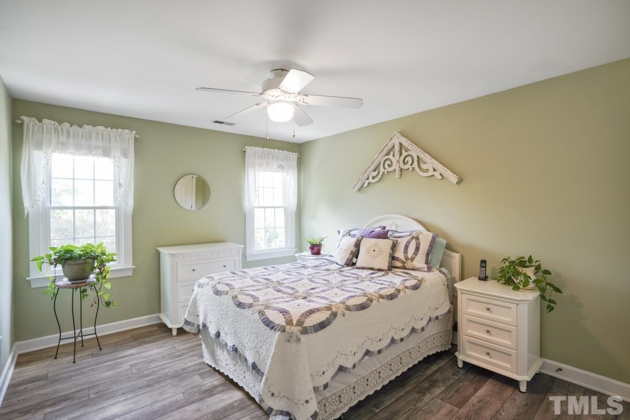 1505 Habbot Drive Raleigh, NC 27603 - Photo 20 of 32 a bedroom with a bed and a potted plant