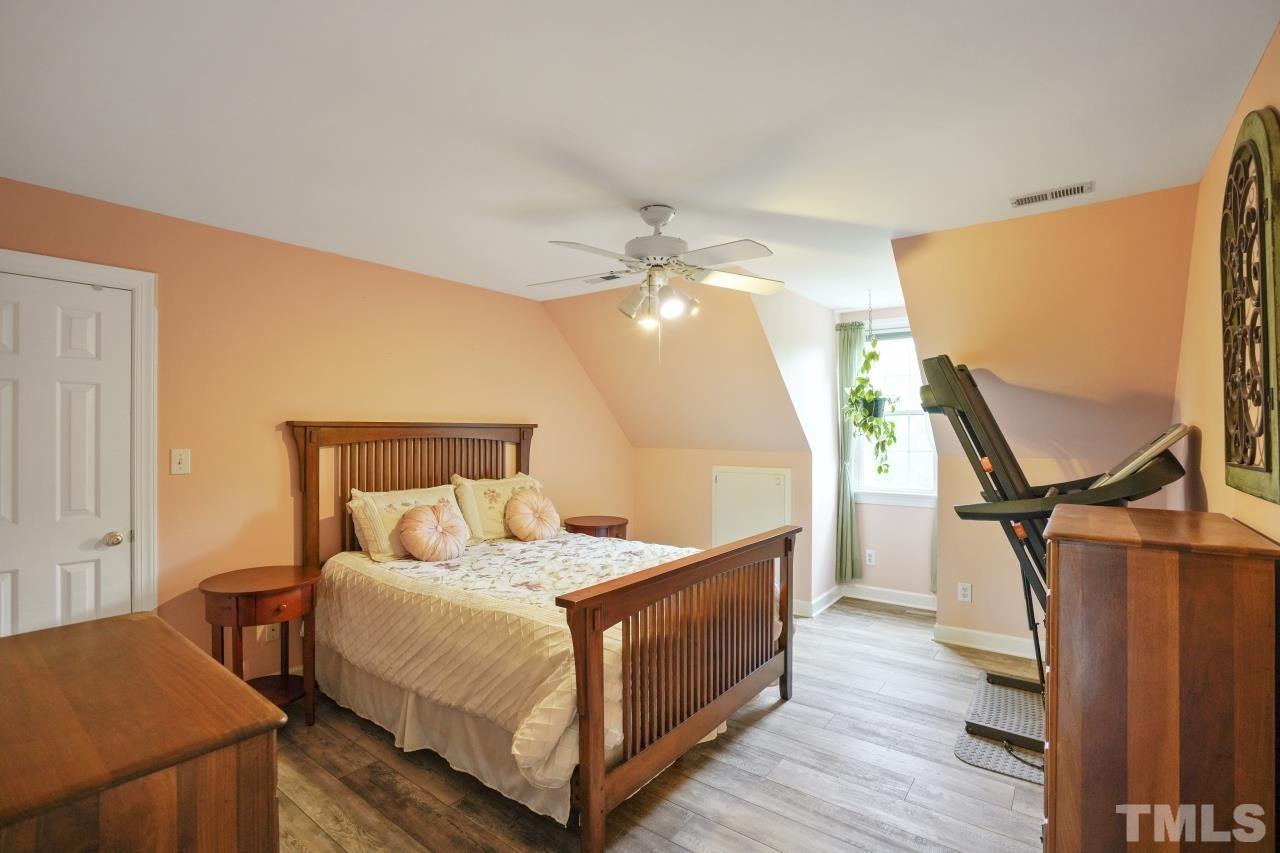 1505 Habbot Drive Raleigh, NC 27603 - Photo 21 of 32 a bedroom with a bed and wooden floor