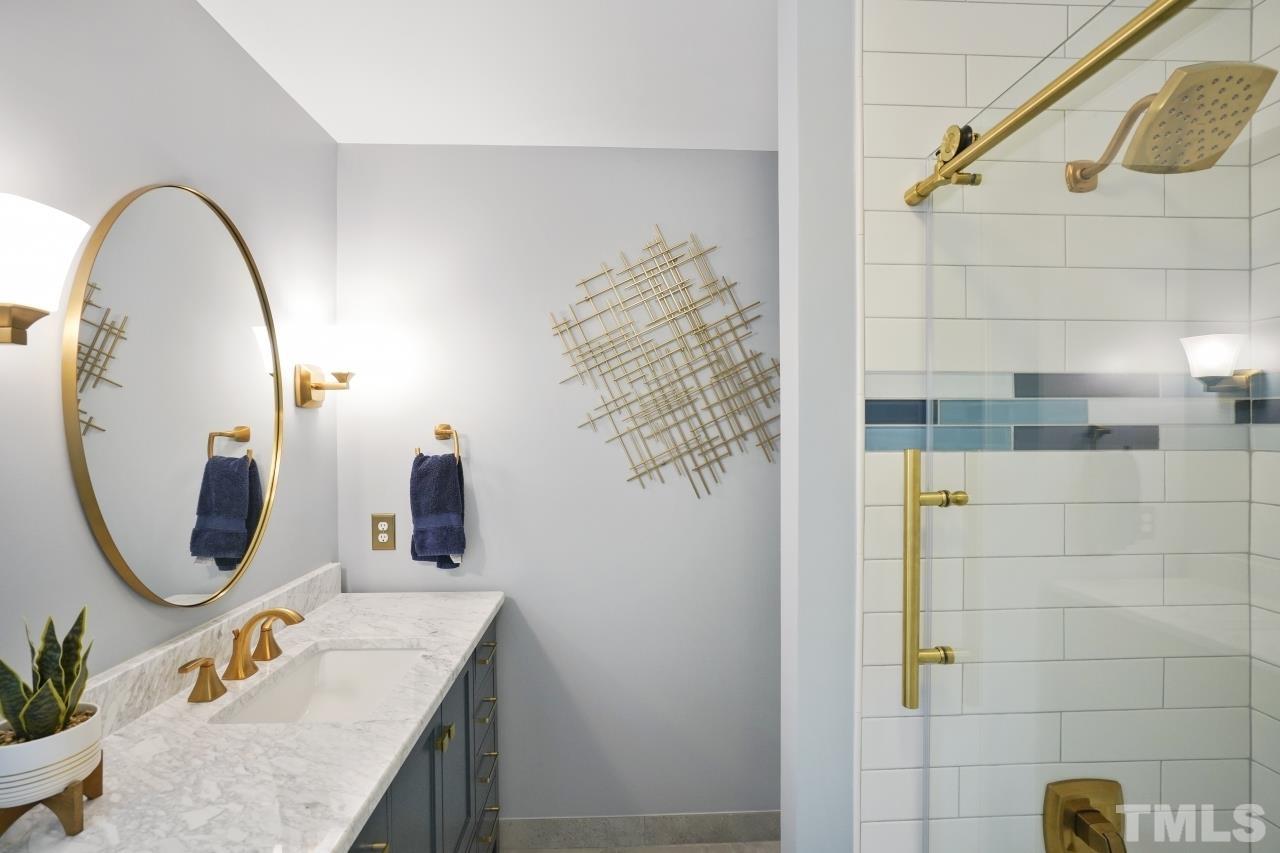 1505 Habbot Drive Raleigh, NC 27603 - Photo 24 of 32 a bathroom with a granite countertop sink and a mirror