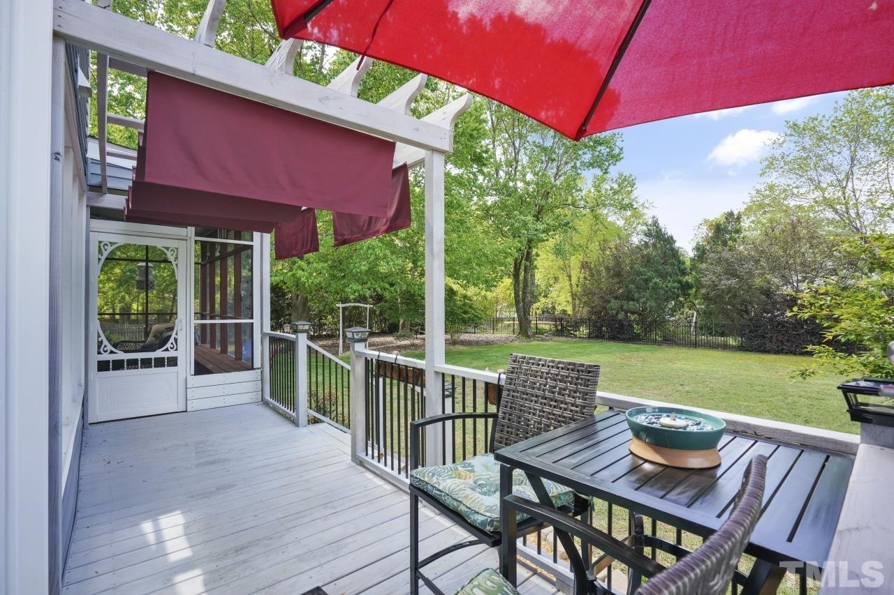 1505 Habbot Drive Raleigh, NC 27603 - Photo 27 of 32 a view of a patio with a table chairs and a backyard