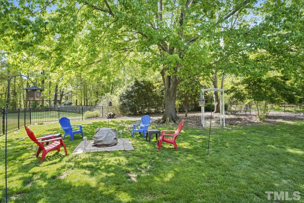 1505 Habbot Drive Raleigh, NC 27603 - Photo 3 of 32 a backyard of a house with table and chairs
