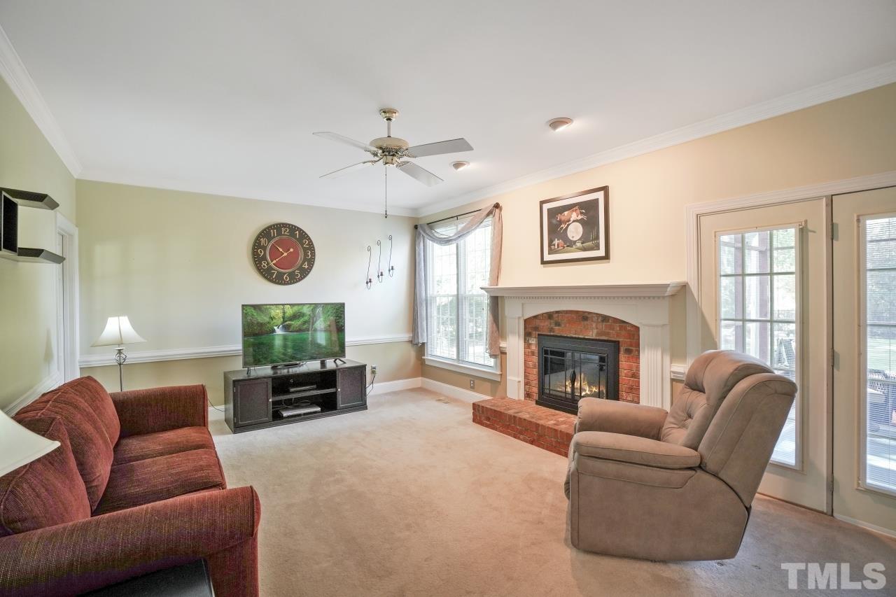 1505 Habbot Drive Raleigh, NC 27603 - Photo 10 of 32 a living room with furniture mirror and fireplace