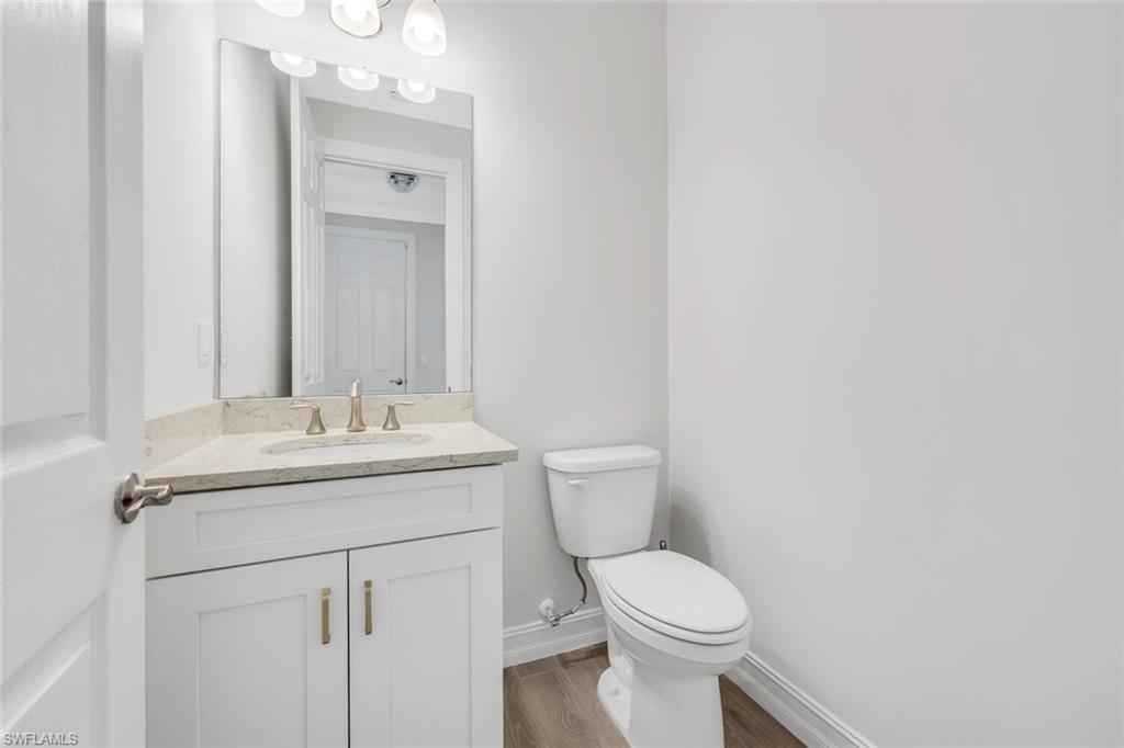 28041 Captiva Shell Loop Bonita Springs, FL 34135 - Photo 11 of 24 a bathroom with a toilet sink and mirror