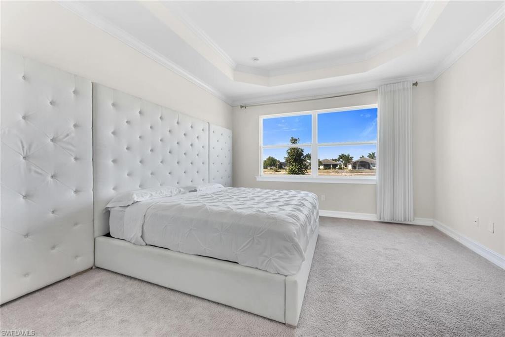 28041 Captiva Shell Loop Bonita Springs, FL 34135 - Photo 12 of 24 a bedroom with a bed and a painting on the wall