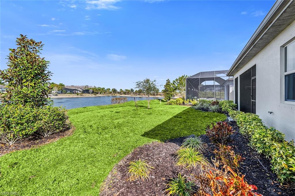 28041 Captiva Shell Loop Bonita Springs, FL 34135 - Photo 17 of 24 a garden with a lake in the back
