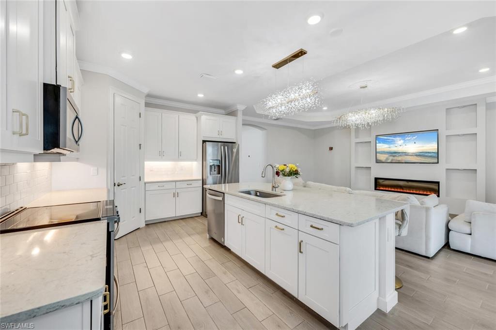 28041 Captiva Shell Loop Bonita Springs, FL 34135 - Photo 24 of 24 a kitchen with white cabinets appliances and sink