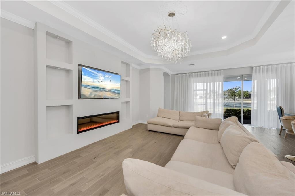 28041 Captiva Shell Loop Bonita Springs, FL 34135 - Photo 3 of 24 a living room with furniture flat screen tv and a chandelier