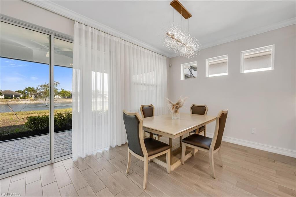 28041 Captiva Shell Loop Bonita Springs, FL 34135 - Photo 5 of 24 a view of a dining room with furniture window and wooden floor