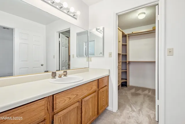 a bathroom with a sink double vanity and a mirror