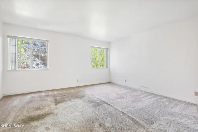 an empty room with windows and window