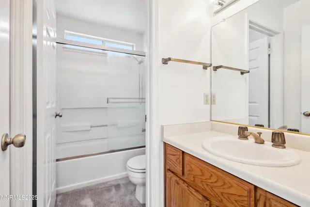 a bathroom with a sink toilet vanity and shower