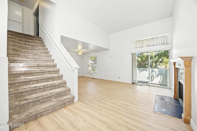 a view of entryway with wooden floor and front door