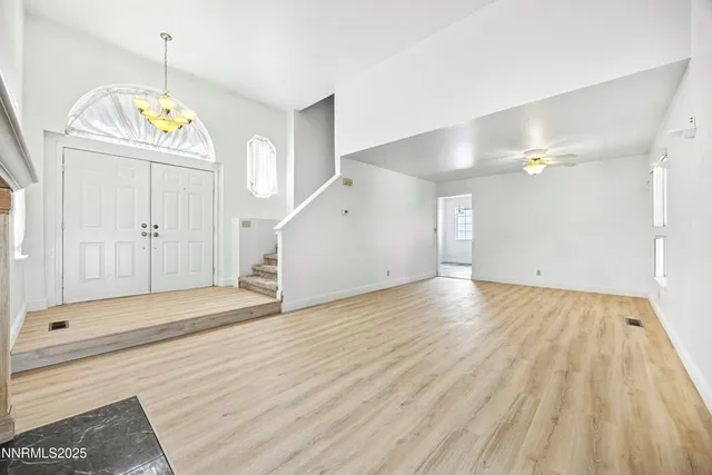 a view of an entryway with wooden floor