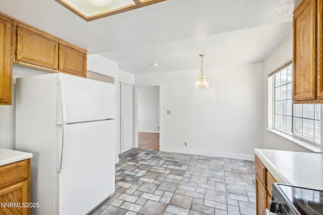 a view of kitchen with a refrigerator washer and a window