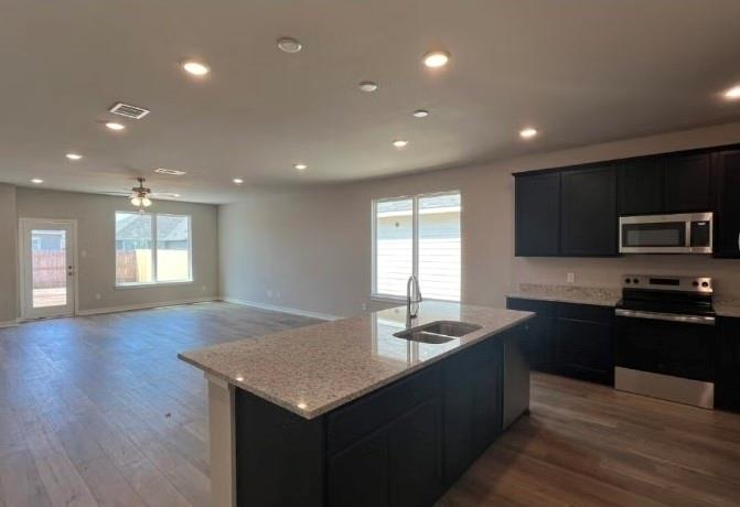 4065 Rimfire Road Waco, TX 76705 - Photo 2 of 4 a kitchen with sink microwave and stove