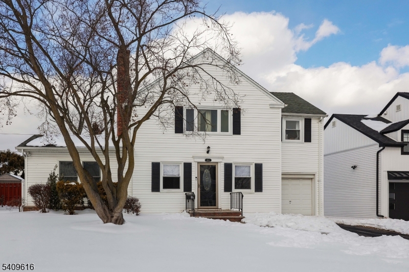 a view of a house with a snow in the background