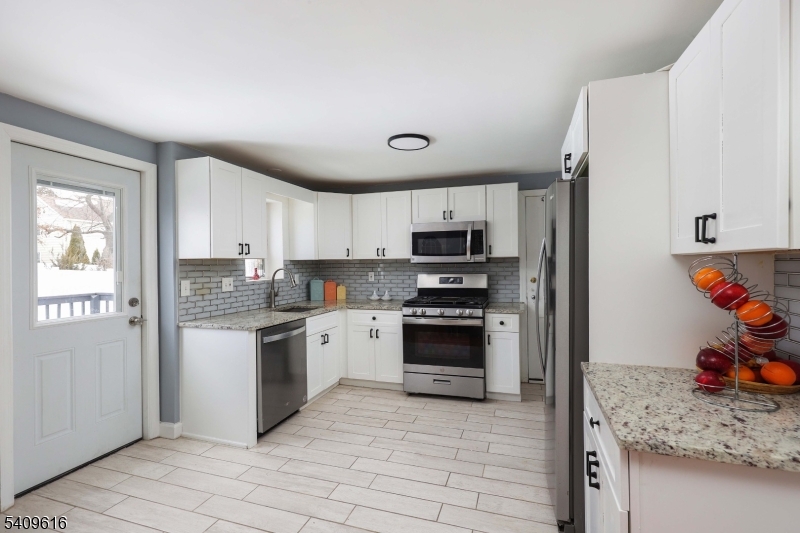 1841 Cider Mill Road Union, NJ 07083 - Photo 12 of 36 a kitchen with stainless steel appliances granite countertop a refrigerator and a sink