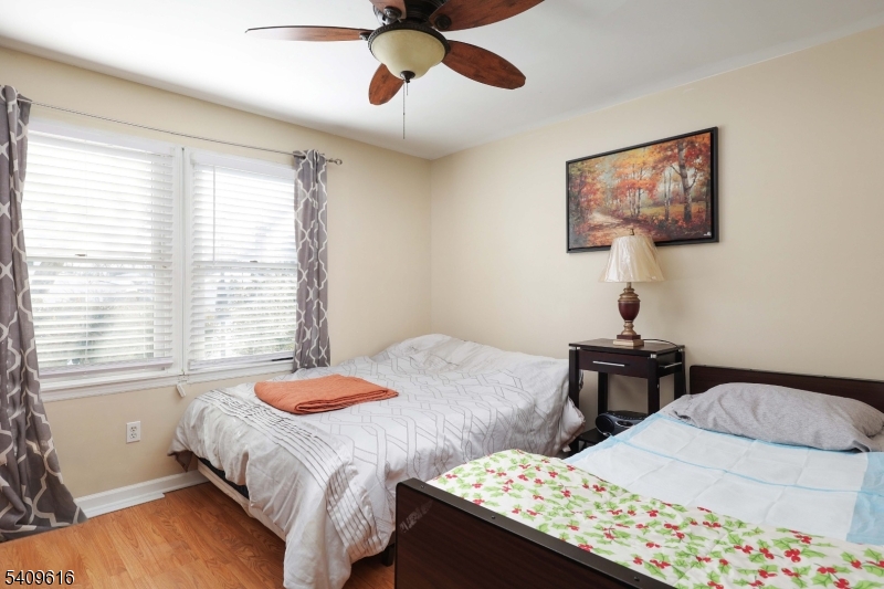 1841 Cider Mill Road Union, NJ 07083 - Photo 19 of 36 a bedroom with a bed and a chandelier