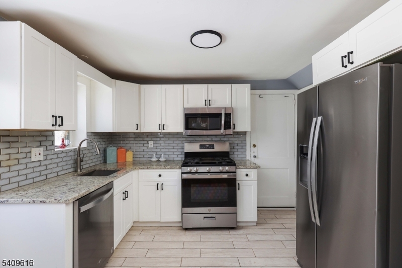 1841 Cider Mill Road Union, NJ 07083 - Photo 9 of 36 a kitchen with stainless steel appliances granite countertop a refrigerator sink and stove