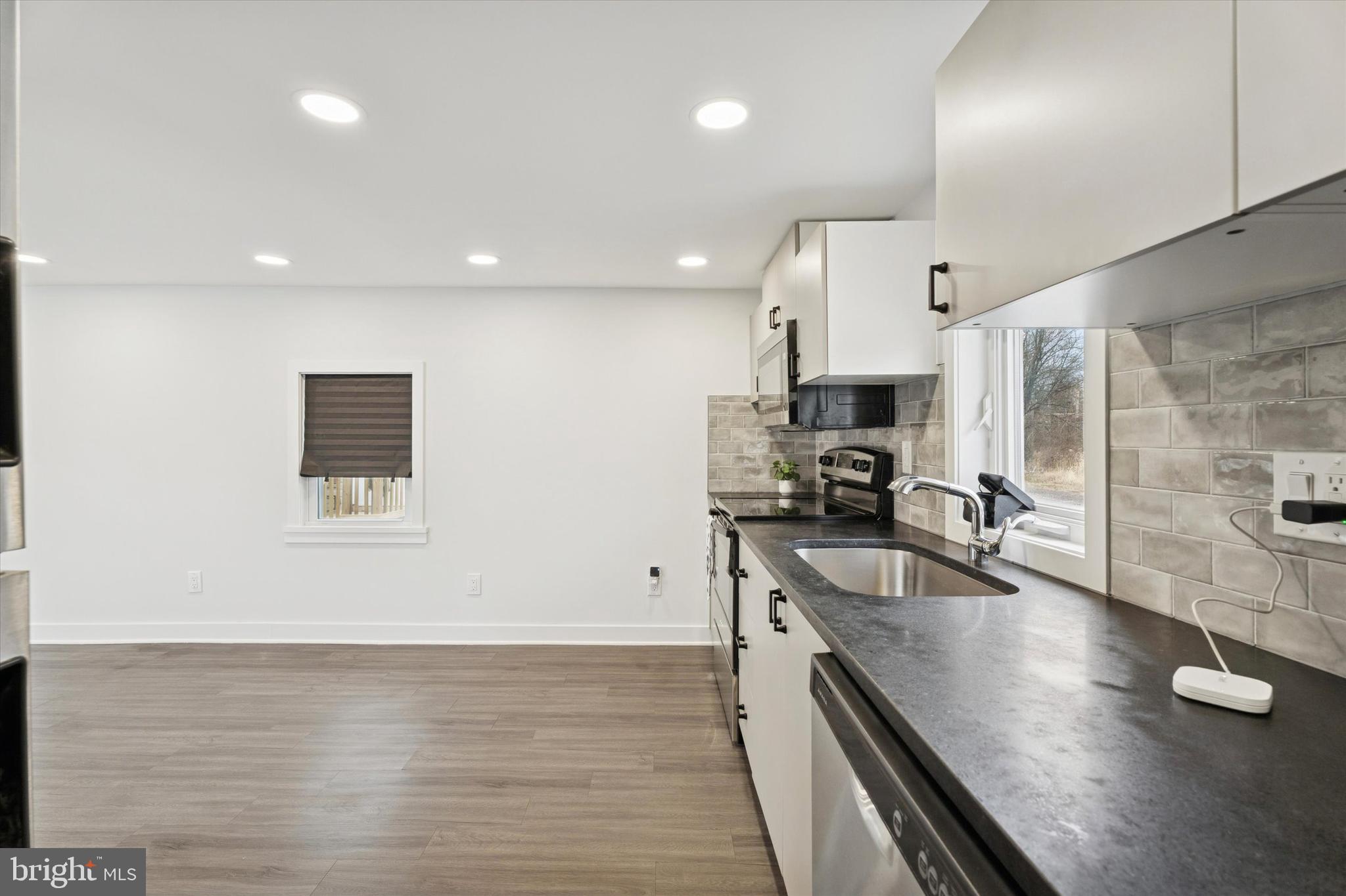 841 Cypress Ave Spring Spring City, PA 19475 - Photo 3 of 15 a kitchen with stainless steel appliances granite countertop a sink stove and refrigerator
