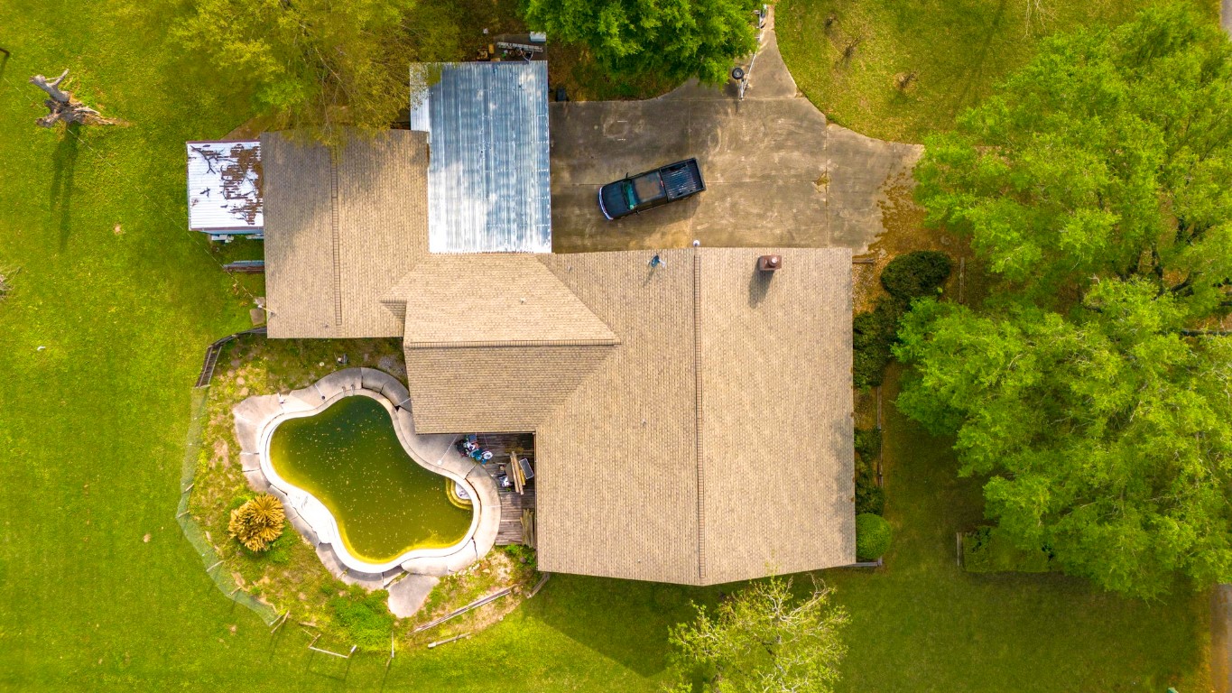 5534 Avanak Street Spring, TX 77389 - Photo 8 of 13 Great roof job! Look at that footprint! Oh, that concrete driveway is perfect for your vehicles, RV, ATV, trailers...etc. Build an iron rod fence and protect your property in style like the neighbors! One side is already done for you!