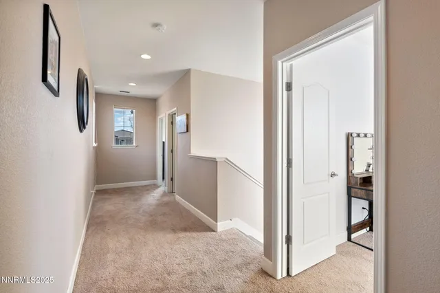 a view of hallway with bathroom and mirror