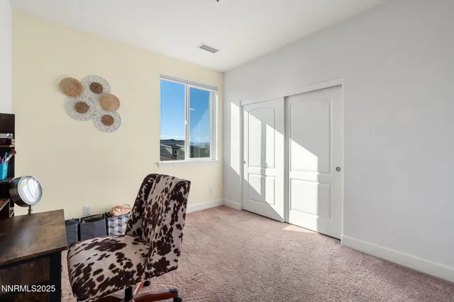 a bedroom with a bed table and chair
