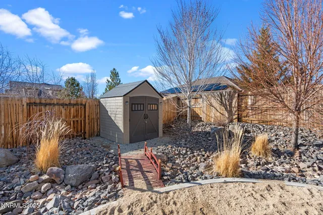 an aerial view of a house with a mountain