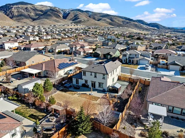 an aerial view of a house with a yard