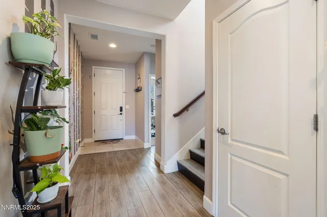 a view of entryway with furniture and wooden floor