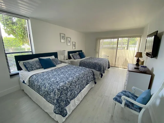 a bedroom with bed and glass window