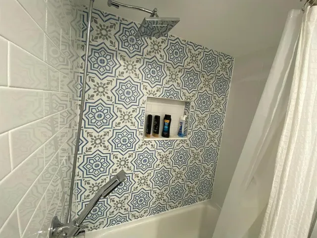 a bathroom with a shower and a sink