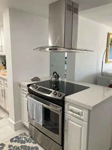 a stove top oven sitting inside of a kitchen