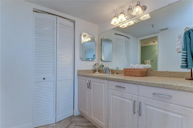 a bathroom with a sink vanity and mirror