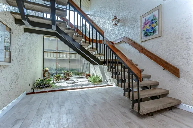 a view of entryway with wooden floor and stairs