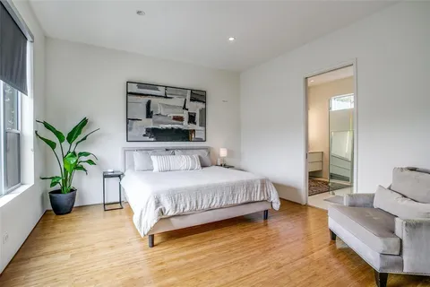 a spacious bedroom with a large bed and a couch