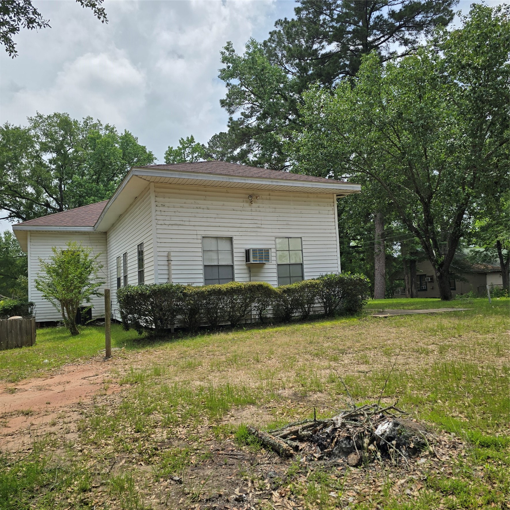 142 Rowe Lane Moscow, TX 75960 - Photo 16 of 16 a view of a white house next to a yard with big trees