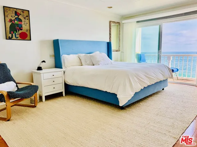 a bedroom with a bed and a chair