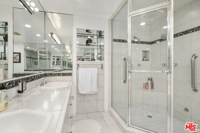 a bathroom with a shower and a sink