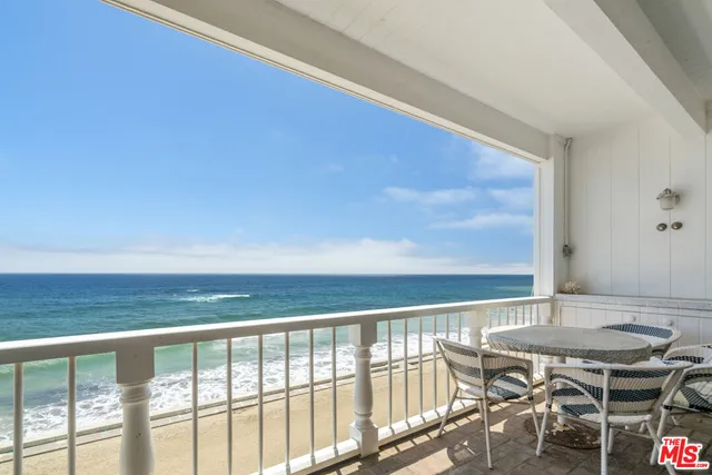a view of a balcony with table and chairs