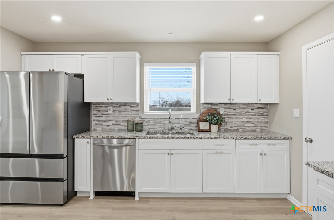 6950 Stallion Road Temple, TX 76501 - Photo 12 of 41 a kitchen with stainless steel appliances a refrigerator sink and cabinets