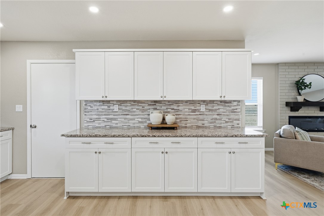 6950 Stallion Road Temple, TX 76501 - Photo 13 of 41 a kitchen with granite countertop a sink and a stove