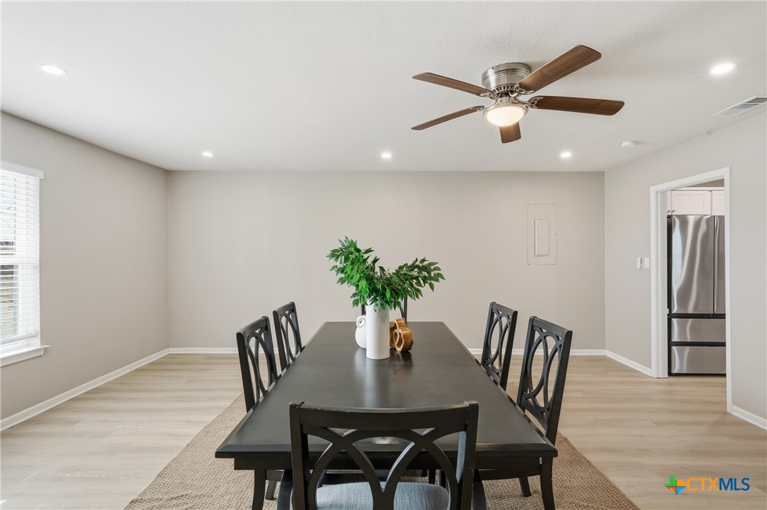 6950 Stallion Road Temple, TX 76501 - Photo 18 of 41 a view of a dining room with furniture and wooden floor