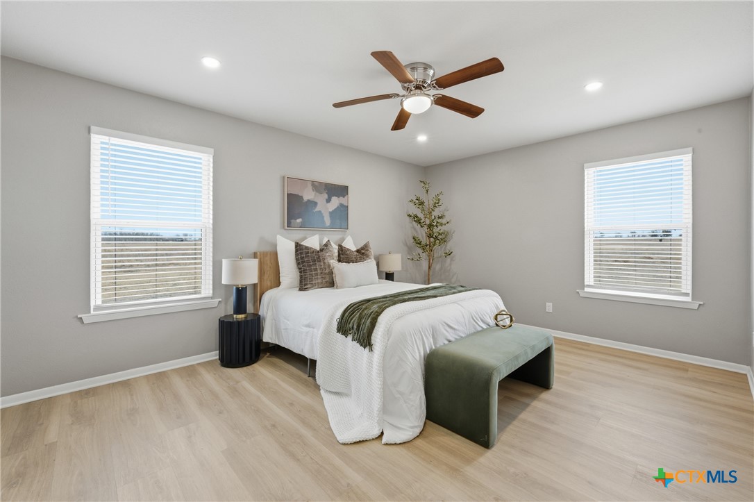 6950 Stallion Road Temple, TX 76501 - Photo 22 of 41 a spacious bedroom with a large bed and a window