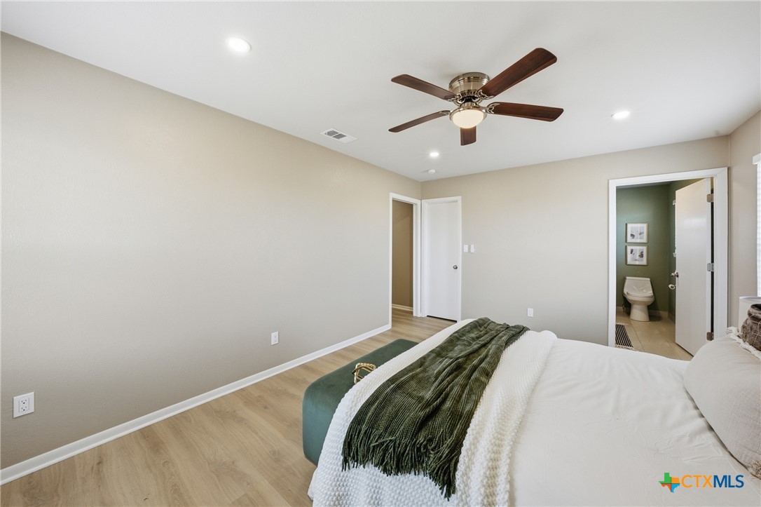 6950 Stallion Road Temple, TX 76501 - Photo 23 of 41 a bedroom with a large bed and a ceiling fan