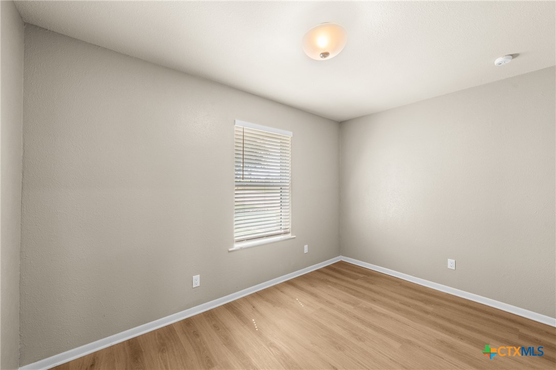 6950 Stallion Road Temple, TX 76501 - Photo 26 of 41 an empty room with wooden floor and windows