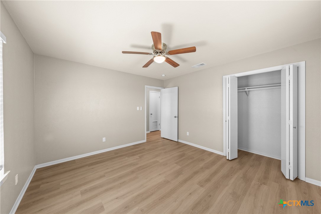 6950 Stallion Road Temple, TX 76501 - Photo 29 of 41 a view of a room with wooden floor and a ceiling fan