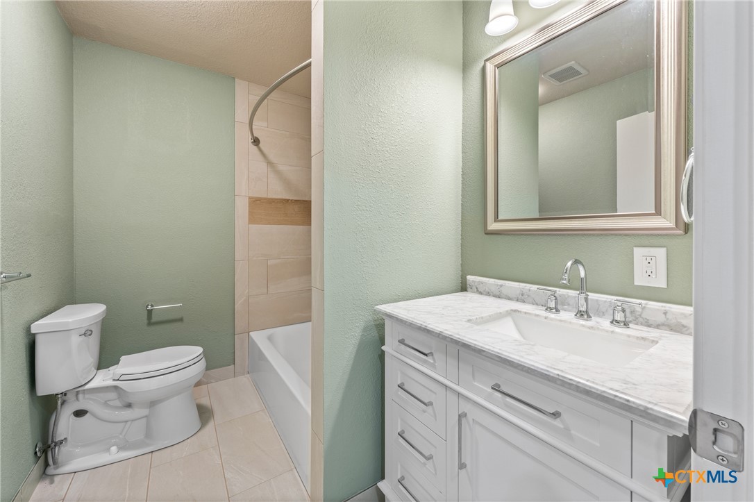 6950 Stallion Road Temple, TX 76501 - Photo 32 of 41 a bathroom with a sink a toilet and a mirror