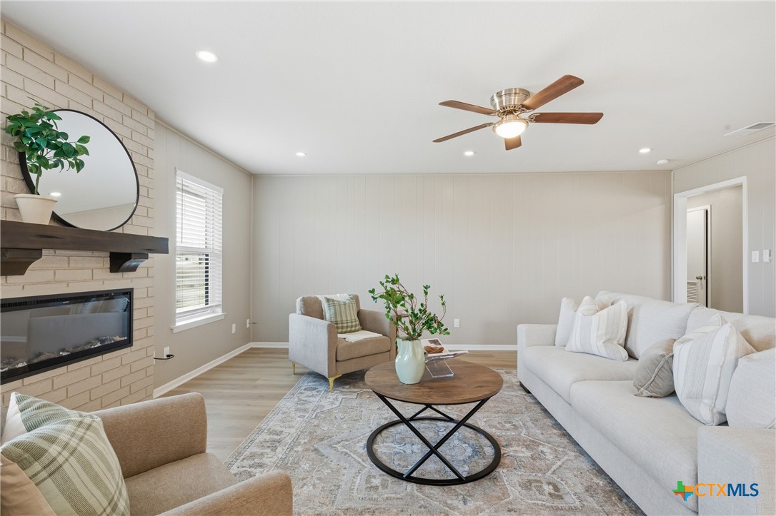 6950 Stallion Road Temple, TX 76501 - Photo 10 of 41 a living room with furniture a fireplace and a potted plant