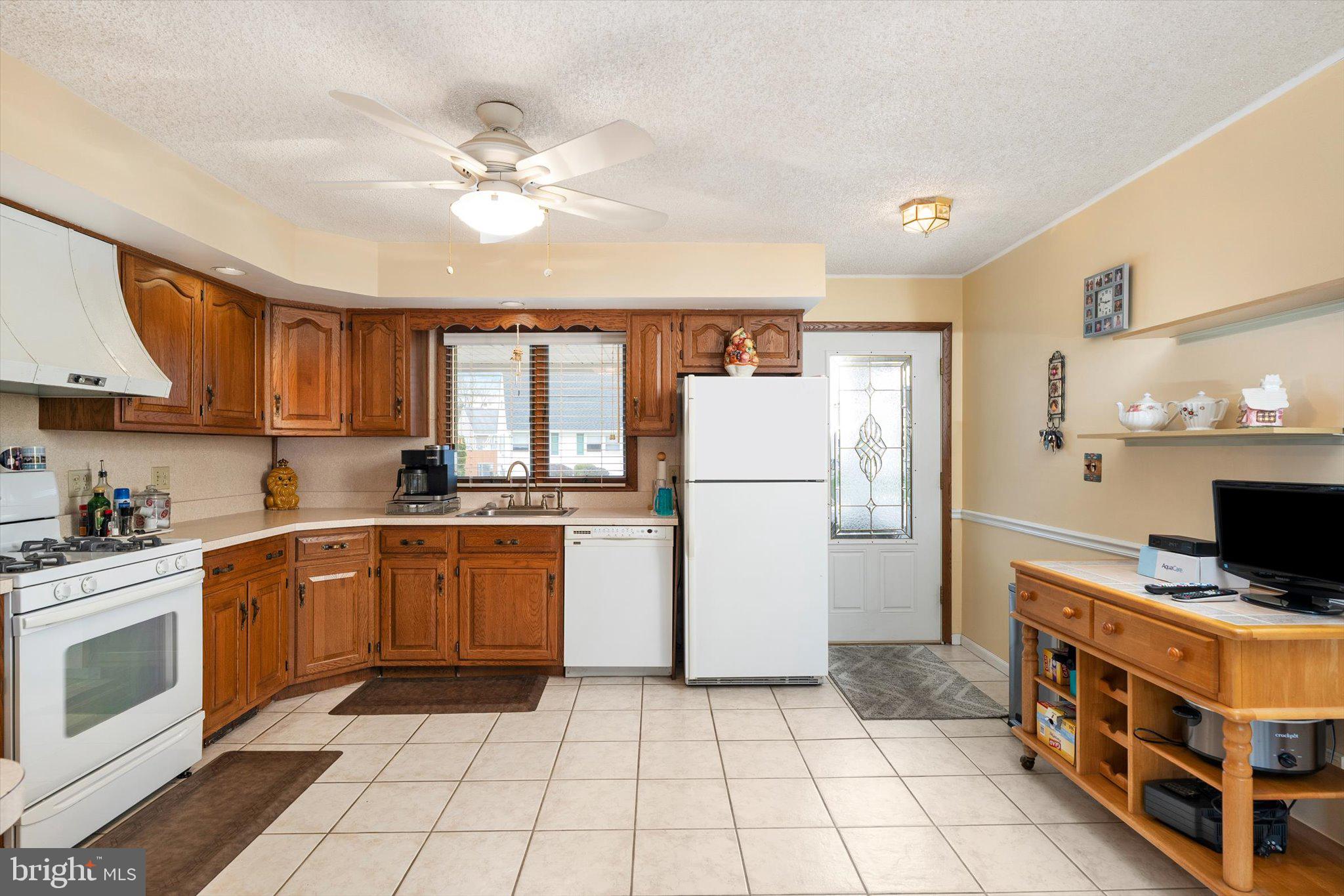 24 Cumberland Road Hamilton, NJ 08690 - Photo 6 of 29 a kitchen with a refrigerator and a stove top oven